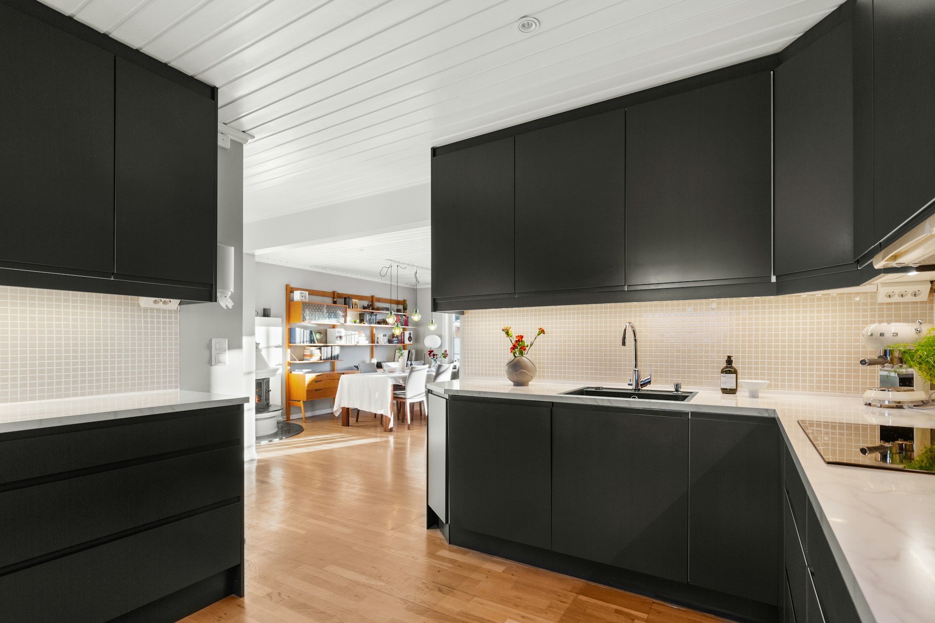 A kitchen with black cabinets and white counter tops